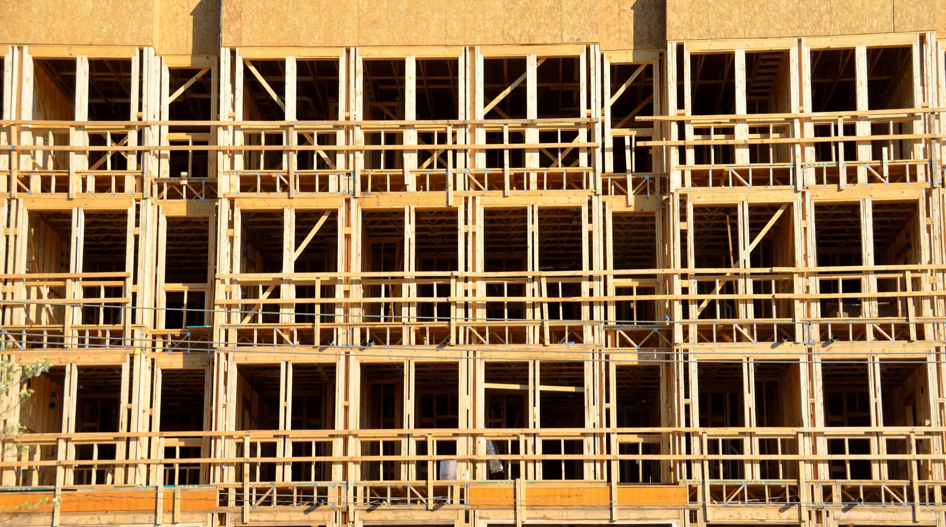 Close view of the wood frame of a multi-story building under construction